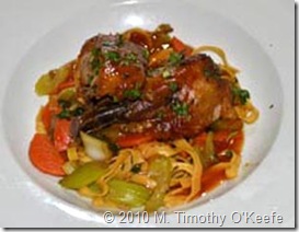 asian style rotisserie of duck w sweet & sour sauce on stir-fried vegetables w soy-splashed fried egg noodles